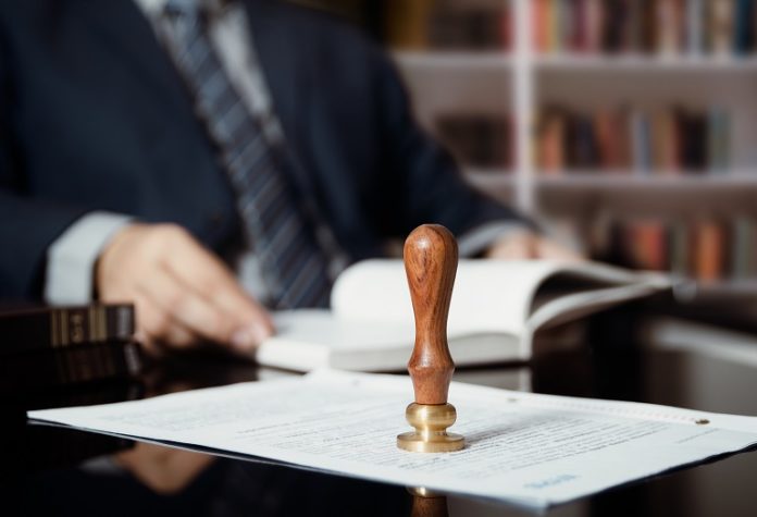 Businessman writing testament at notary public office