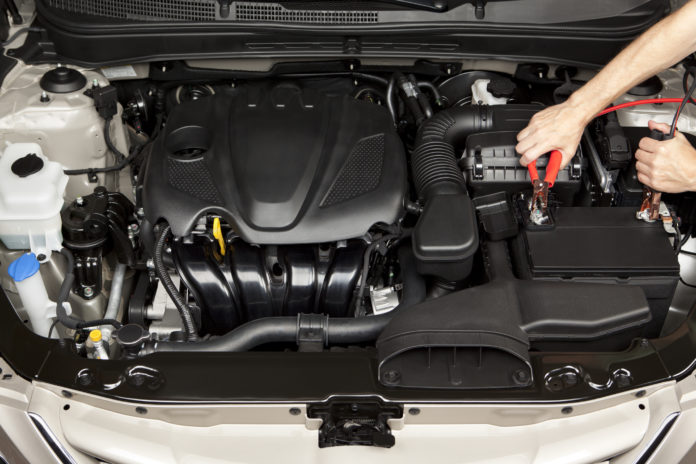 Mechanic Placing Jumper Cables on a Battery