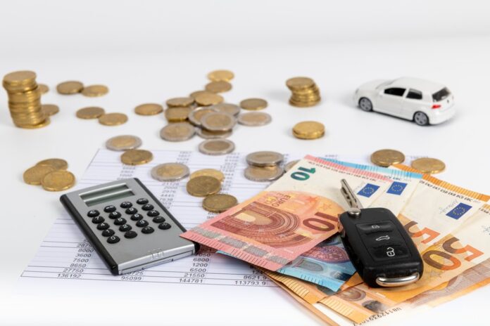 Financial statement with coins and banknotes. Finance and car key, saving money for a car or material design concepts.
